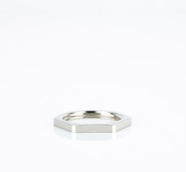 A brass Jacob hexagonal locknut, with Pg thread, on a white background.