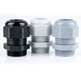 Three plastic (polyamide PA6 V-2) Jacob cable glands (metric) in Gray, white and black on a white background.
