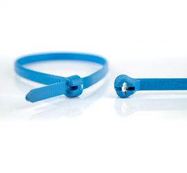 A blue metal detectable Ty-Rap® plastic cable tie with metal pigments, next to the enlarged head of another Ty-Rap® cable tie.