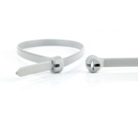 Een grijze Ty-Rap® kunststof kabelbinder, naast een uitvergrote sluiting van een andere Ty-Rap® kabelbinder.
