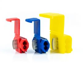 A red, a blue and a yellow quick splice connector, on a white background.