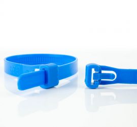 A releasable blue plastic cable tie, next to the enlarged head of another blue releasable cable tie.