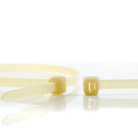 An extra heat-resistant plastic cable tie, next to the enlarged head of another extra heat-resistant cable tie.