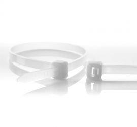 A releasable natural colored plastic cable tie, next to the enlarged head of another natural colored releasable cable tie.