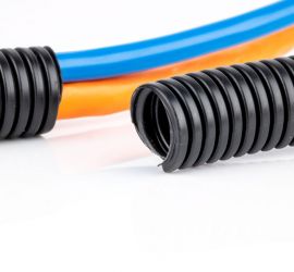 Black corrugated tubing, standard issue, with a piece of corrugated tubing with cables guided through it in the background.