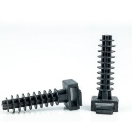 Two black wallplugs for cable ties, one pictured lying down and one pictured standing upright, on a white background.