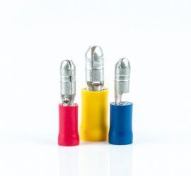 A red, a yellow and a blue insulated bullet disconnector, male, standing upright on a white background.