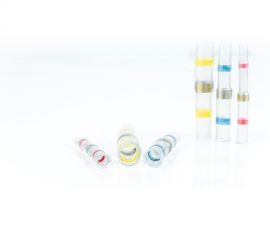 Two red, two yellow and two blue heat shrinkable solder butt connectors, insulated, three standing upright and three lying down, on a white background.