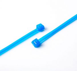 Two blue Tefzel® cable ties on a white background.
