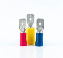 A red, a yellow and a blue insulated blade connector, without sleeve, standing upright, on a white background.