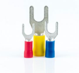 A red, a yellow and a blue insulated spade terminal, without sleeve, standing upright, on a white background.